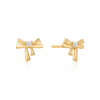 Sølvforgyldte ørestikker fra Støvring Design, sløjfeform med lille sten i midten, gylden farve.