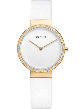 Dameur fra Bering med guldur, hvid rem og bezel med klare sten. Minimalistisk urskive.